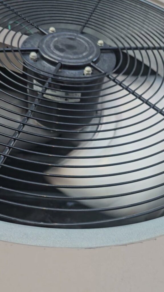 A close-up view of an outdoor AC unit's fan, showcasing HVAC equipment by Henry Refrigeration & Hvac Utah in Ogden, UT.