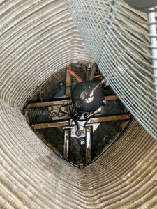 Close-up view of an outdoor AC unit's fan motor and coils, showing components serviced by Steadfast Mechanical in Gilbert, AZ.