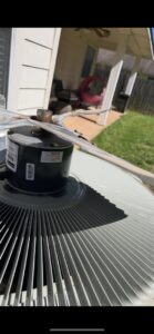 A close-up view of an outdoor AC unit's fan and motor during an inspection or repair by Air Advisors of Louisiana in Shreveport, LA.