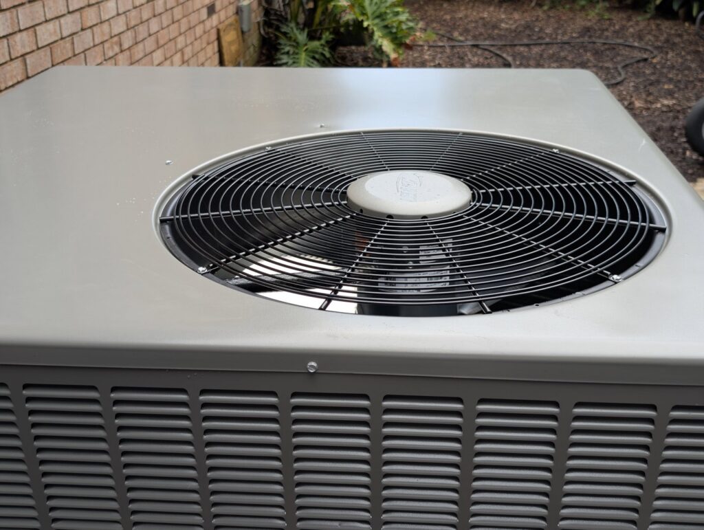 A close-up view of the top fan of an outdoor air conditioning unit, serviced by Pardee Service Experts in Charleston, SC.