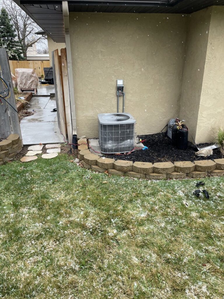 An outdoor air conditioning unit installed in a snowy environment by ICare Heating & Air in Millcreek, UT.