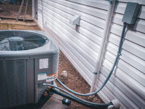 An outdoor air conditioning unit with visible connections, installed by A & A Air Conditioning & Heating in Little Rock, AR.