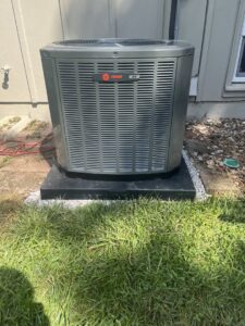 A newly installed Trane XR outdoor AC unit by A-Team PHC in Olathe, KS, ready to provide cooling.