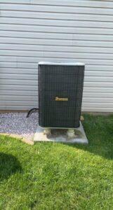 An outdoor air conditioning unit installed next to a residential building by Affordable Heating & Cooling in Lafayette, IN.