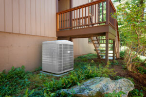 A newly installed outdoor AC unit next to a residential home by Air Fix in Fayetteville, AR.