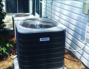 An outdoor air conditioning unit installed next to a residential building by Airtechservicesohio.com in Columbus, OH