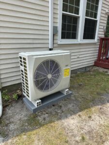 An outdoor AC unit installed by BC Express Inc Heating & Air Conditioning next to a home in Toms River, NJ.