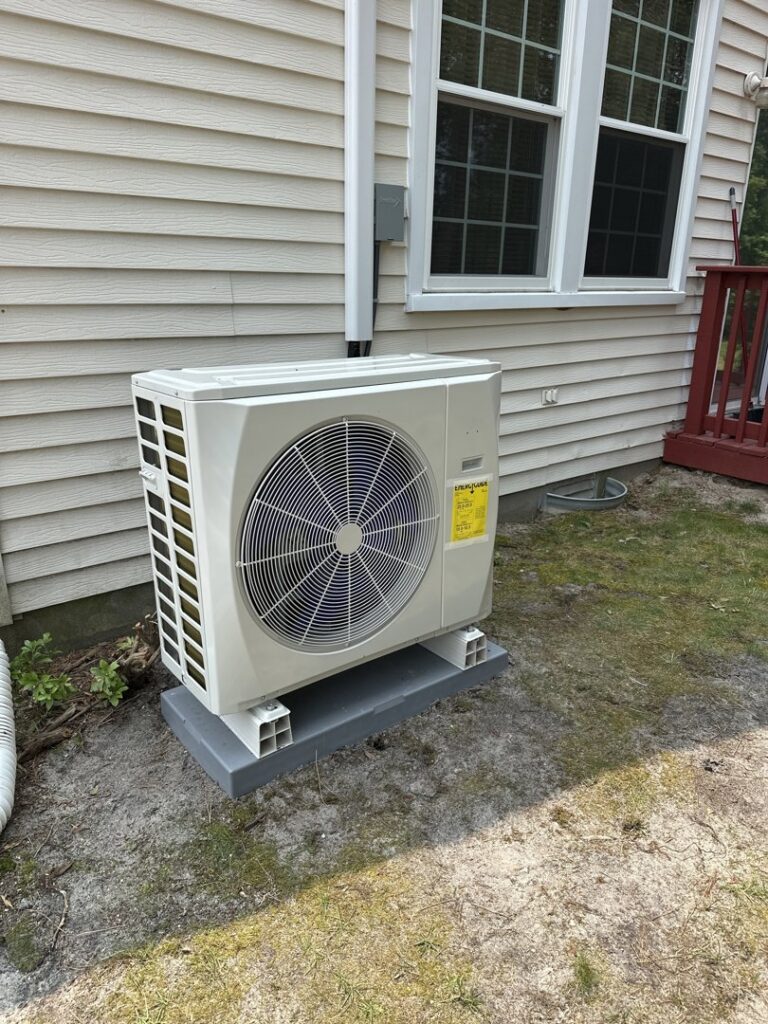An outdoor AC unit installed by BC Express Inc Heating & Air Conditioning next to a home in Toms River, NJ.