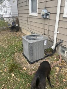 An outdoor air conditioning unit installed next to a house, serviced by Crain Heating and Cooling in Jeffersonville, IN.