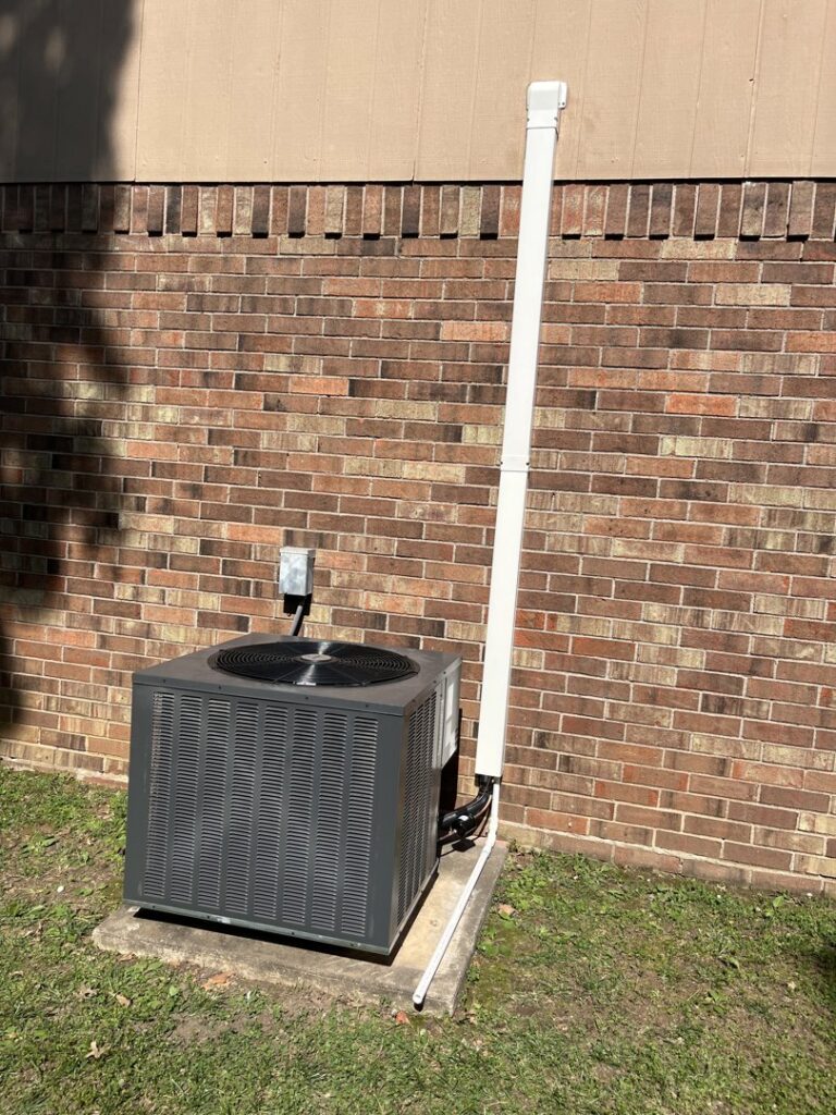 An outdoor AC unit installed next to a brick building by Diversified Services NA in Rogers, AR.