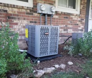 An outdoor air conditioning unit installed next to a brick house by Done Right Air in West Allis, WI