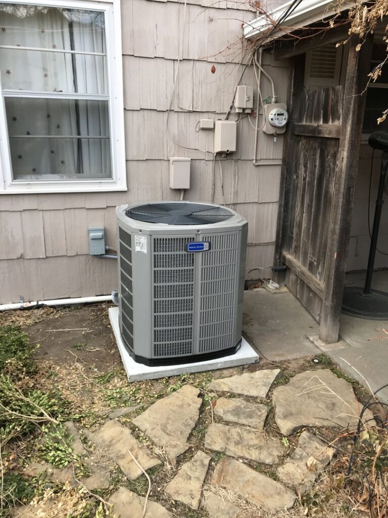 An outdoor air conditioning unit installed next to a residential home by Epic Heating & Cooling in Wichita, KS.