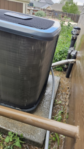A newly installed or serviced outdoor AC unit with visible piping by Erik's Quality HVAC LLC in Greeley, CO.