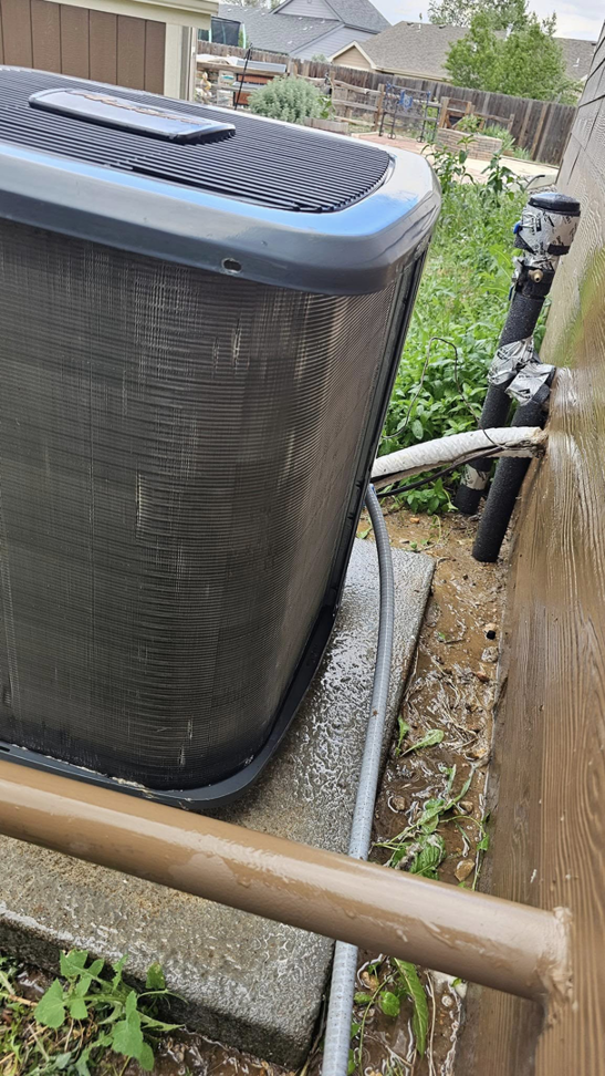 A newly installed or serviced outdoor AC unit with visible piping by Erik's Quality HVAC LLC in Greeley, CO.