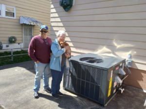 A newly installed Rheem outdoor AC unit next to a building by George Mechanical in Charleston, WV.