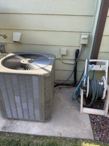 An outdoor AC unit recently installed next to a home by Great Plains Heating & Air in Goddard, KS.
