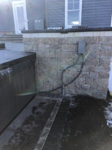 An outdoor AC unit installed next to a hot tub by Inspired Heating & Cooling, Electric, Roofing, Repair LLC in Columbus, OH.