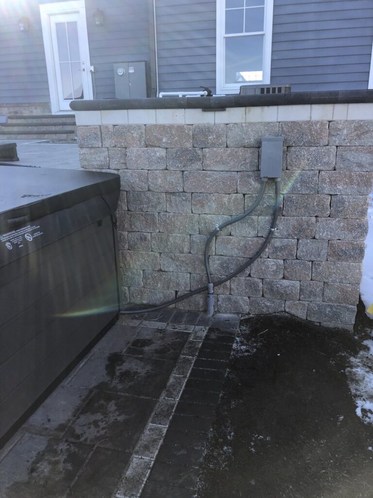 An outdoor AC unit installed next to a hot tub by Inspired Heating & Cooling, Electric, Roofing, Repair LLC in Columbus, OH.