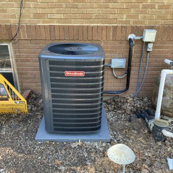 A newly installed Goodman outdoor air conditioning unit next to a brick wall by Lopez Mechanical HVAC in Kansas City, MO.