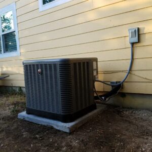 A newly installed outdoor AC unit next to a residential building by Manuel & Sons Service Co. in San Antonio, TX.
