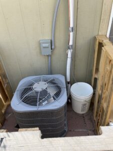 An outdoor AC unit installation with refrigerant lines by NM Heating and Air in Albuquerque, NM.