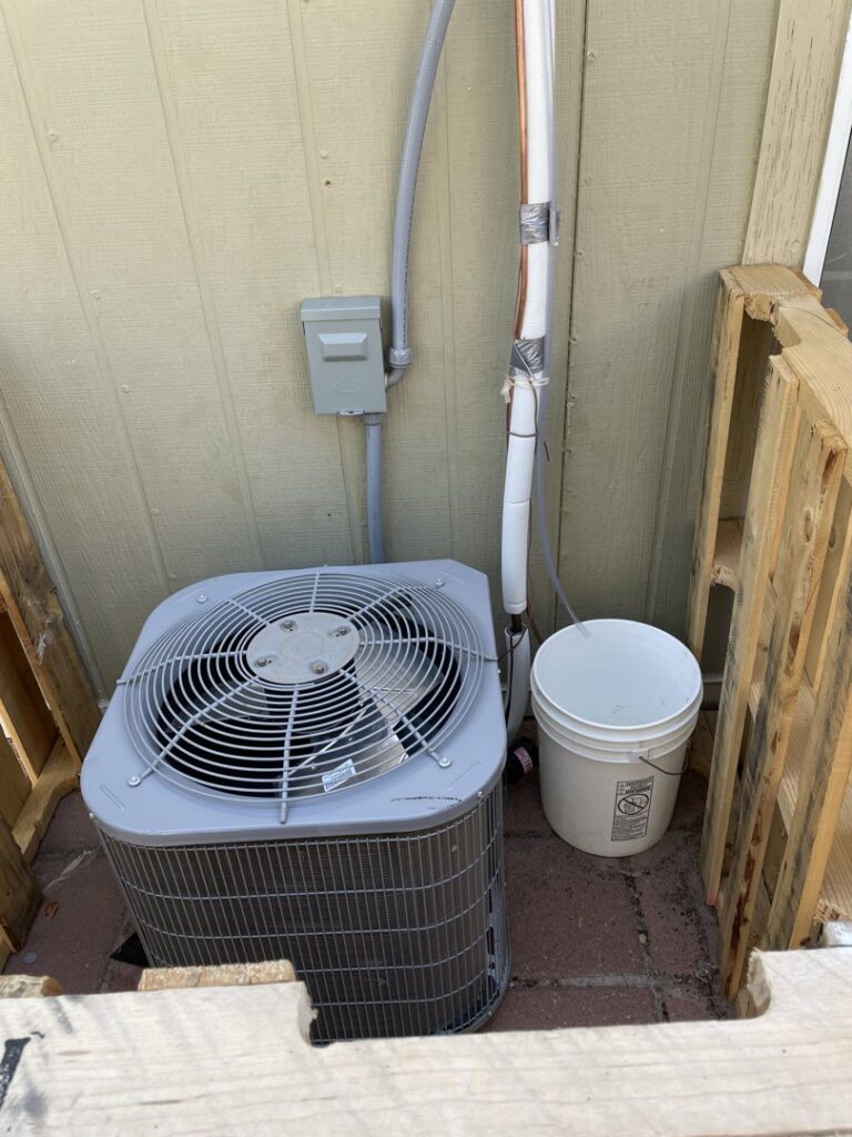 An outdoor AC unit installation with refrigerant lines by NM Heating and Air in Albuquerque, NM.