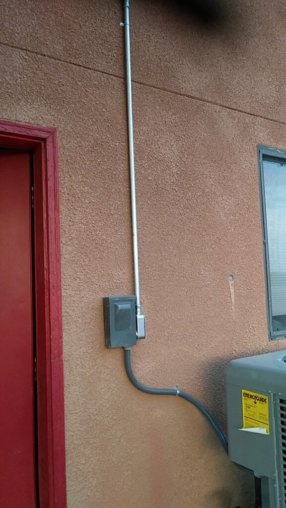 An outdoor air conditioning unit with electrical conduit, indicating installation or service by Number 1 Plumber in Washington, DC.