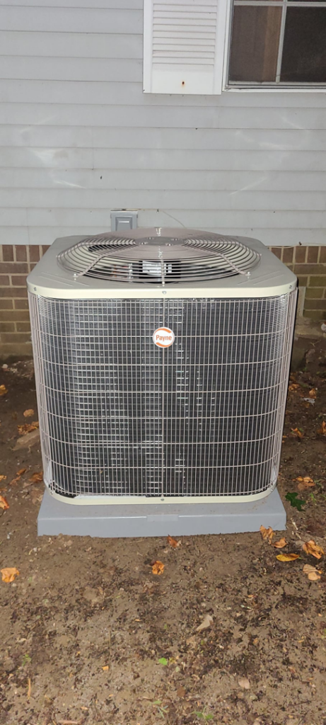 A Payne brand outdoor AC unit professionally installed next to a home by Air Mechanics, LLC in Greensboro, NC.