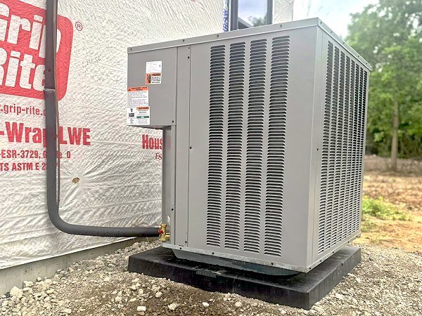 An outdoor air conditioning unit installed at a new construction site by QC Mechanical, Inc. in Lockport, NY.