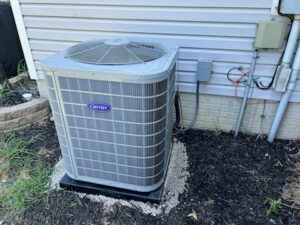 A newly installed Carrier outdoor air conditioning unit by Raymond Plumbing, Heating & Air Conditioning in Lorain, OH.