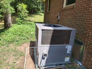 A newly installed outdoor AC unit next to a brick house by Recovery HVAC in Smyrna, TN.