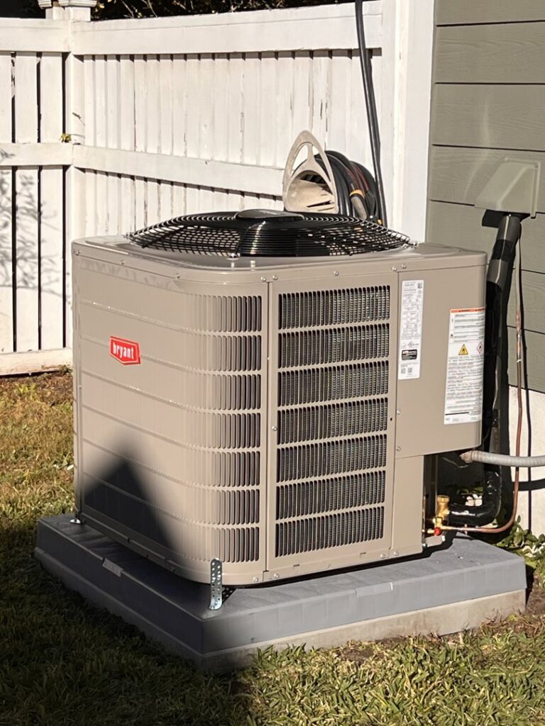 A newly installed Bryant outdoor AC unit next to a home by Reliable Heating and Air LLC in Summerville, SC.