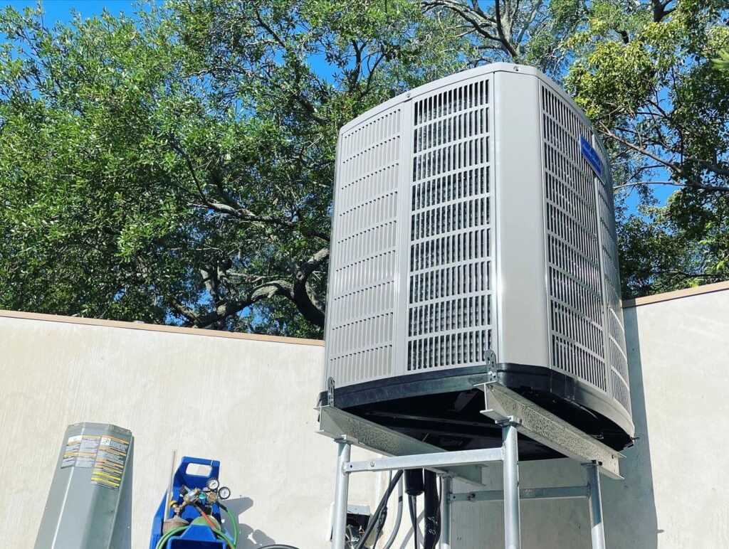 An outdoor AC unit installed on an elevated stand with HVAC tools nearby by Air Zero in Largo, FL