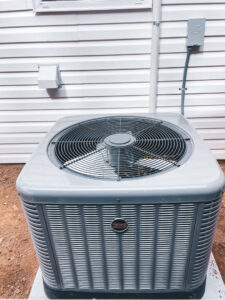 An outdoor air conditioning unit installed next to a residential building by A & A Air Conditioning & Heating in Little Rock, AR.