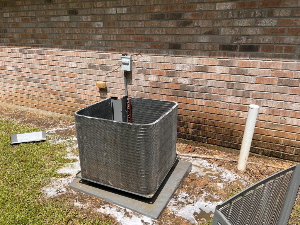 An outdoor air conditioning unit undergoing maintenance or repair by Johnson's A/C & Heating in Alexandria, LA.