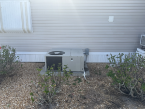 An outdoor AC unit installed for a mobile home by NextGen Aire of Southwest Florida in Punta Gorda, FL.