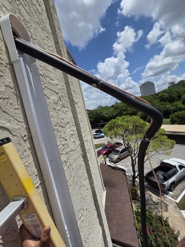 An outdoor AC unit with visible refrigerant lines, serviced by Manuel & Sons Service Co. in San Antonio, TX.