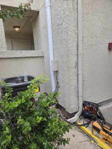 An outdoor AC unit undergoing repair or maintenance by Manuel & Sons Service Co. in San Antonio, TX.