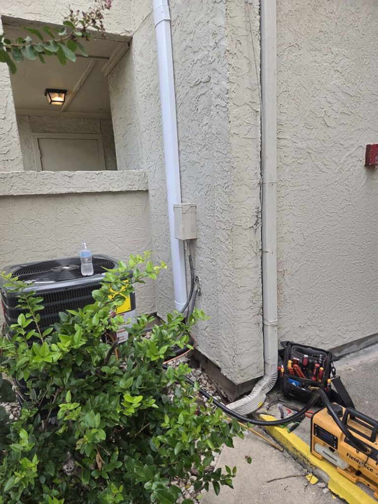 An outdoor AC unit undergoing repair or maintenance by Manuel & Sons Service Co. in San Antonio, TX.