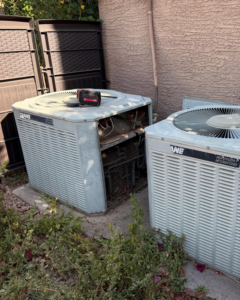 An outdoor Trane air conditioning unit being serviced by a technician from Otto's Air Conditioning & Heating in Mesa, AZ.