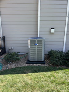 A well-maintained outdoor air conditioning unit installed at a residential property by Friess Heating & Air Conditioning in Topeka, KS