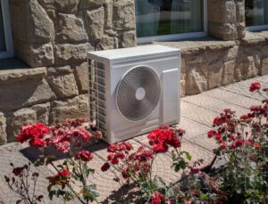 An outdoor AC unit installed next to a residential building, showcasing work by NorthStar Services in South Haven, MN