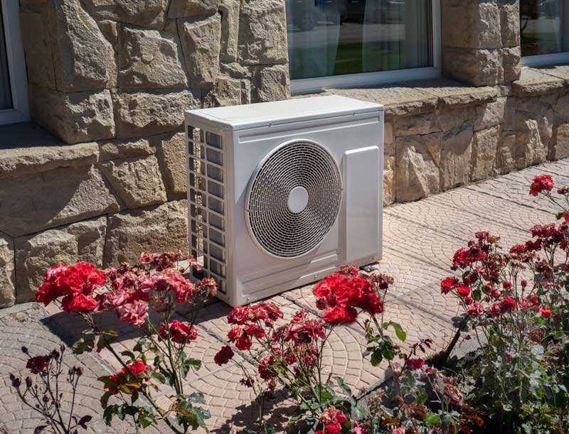 An outdoor AC unit installed next to a residential building, showcasing work by NorthStar Services in South Haven, MN