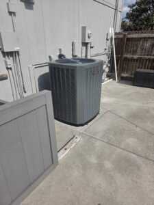 A modern outdoor air conditioning unit installed at a residential property by Pro-Cool Air Conditioning & Heating in Blue Springs, MO.