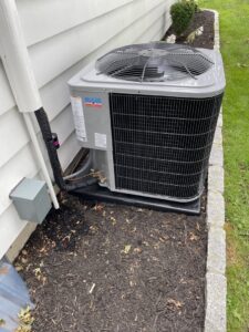 An outdoor air conditioning unit providing cooling for a residential home by MAC Heating and Cooling LLC in Waterbury, CT.