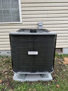 A residential outdoor air conditioning unit installed next to a house by Trenary Service Company in Martinsburg, WV.