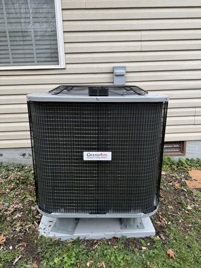 A residential outdoor air conditioning unit installed next to a house by Trenary Service Company in Martinsburg, WV.