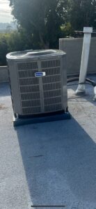 An outdoor air conditioning unit installed on a rooftop by Genesis - Heating and Air Conditioning Specialist in SUNNYSIDE, NY