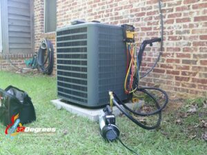 An outdoor AC unit being serviced with gauges and tools by 32 Degrees Heating and Air Conditioning in Las Vegas, NV