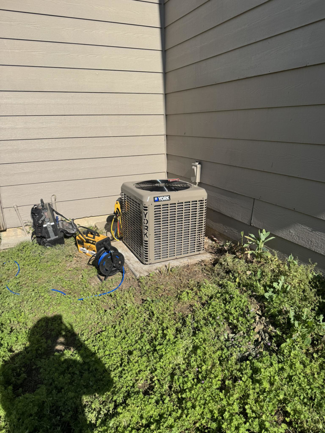 An outdoor York AC unit being serviced by G.M. AIR Conditioning & Heating in Wichita, KS.
